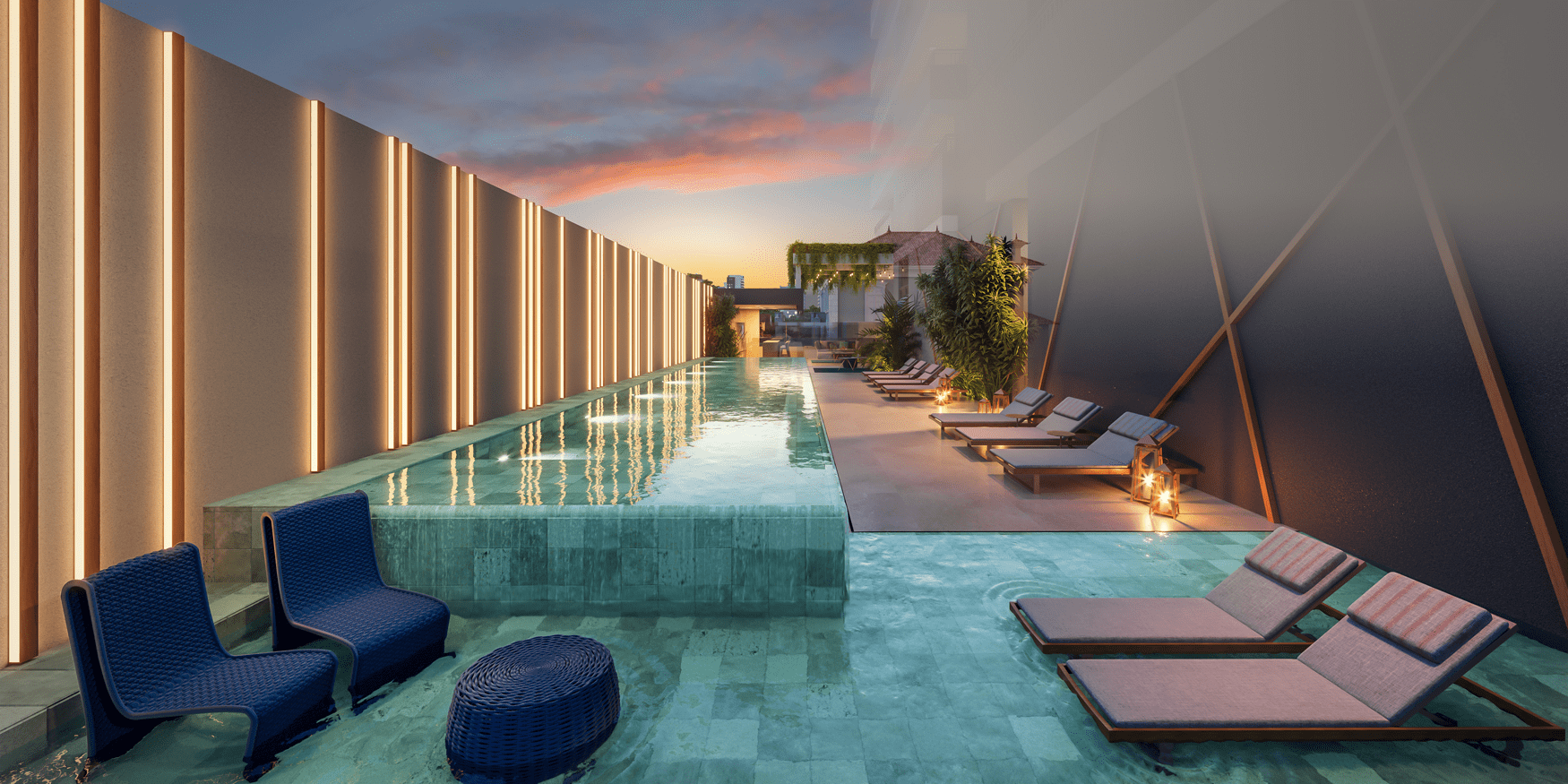 Piscina de cobertura com design moderno, iluminação ambiente nas paredes e na água, espreguiçadeiras e cadeiras de lounge ao redor, com um pôr do sol colorido ao fundo.