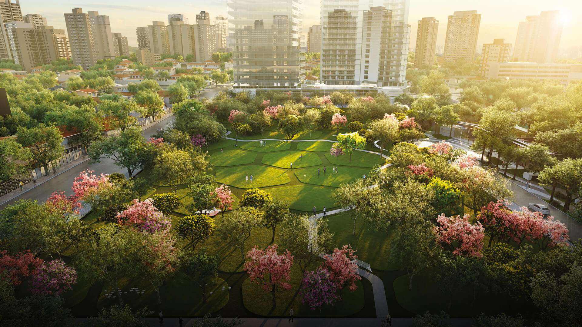 Jardim com muitas árvores de folhas com cores rosa, lilás e verde, ao redor prédios e m céu de fim de tarde